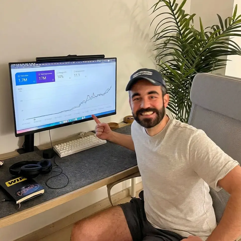 Javi at his desk, pointing at a chart on his screen